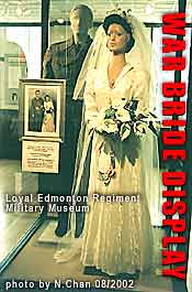 Orignal bridal gown shared by War Brides circa 1945, in  military museum display case